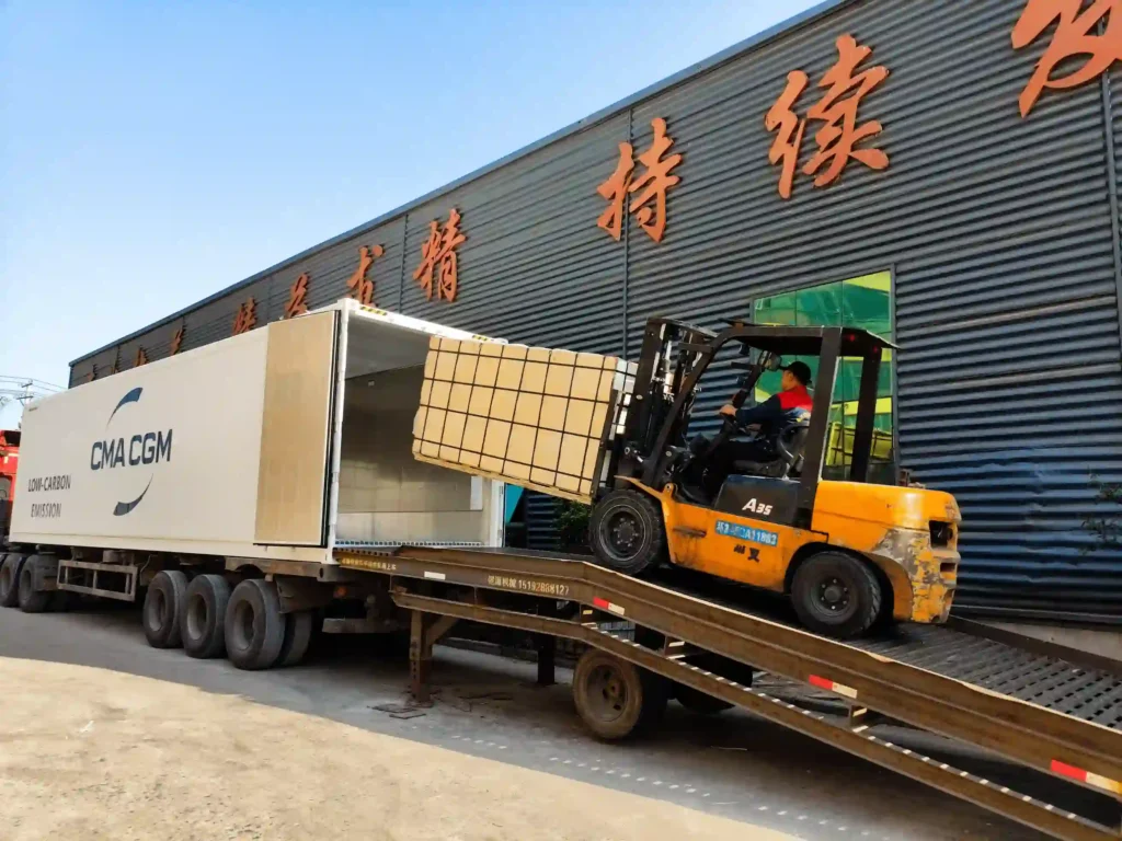 Forklift loading packed WPC decking products into a shipping container at Supereco factory for international bulk export