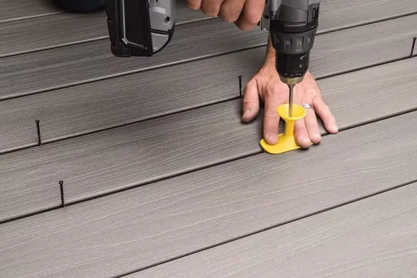 Installing low maintenance bulk composite decking planks from a reliable manufacturer.