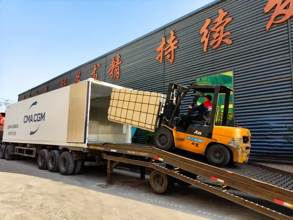 Forklift loading packed WPC decking products into a shipping container at Supereco factory for international bulk export