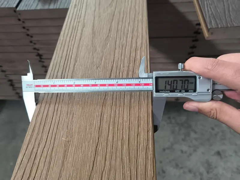 Supereco factory worker measuring a WPC decking board with a digital caliper