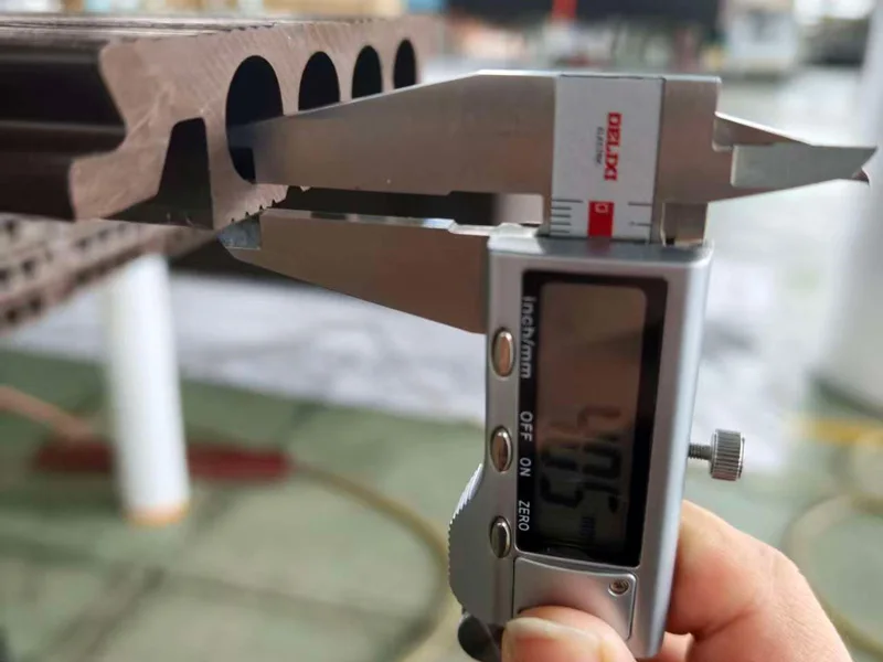 Digital caliper checking wall thickness of hollow WPC decking profile