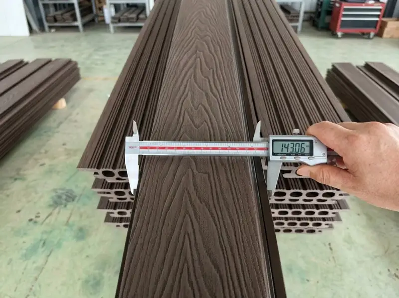 Factory QC worker measuring WPC decking profile width with caliper