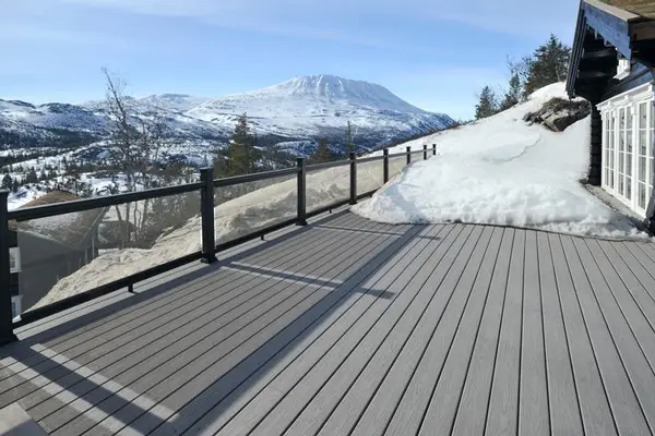Weather-resistant composite decking installed in snowy mountain environment