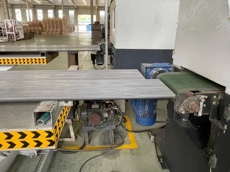 WPC decking boards moving through a manufacturing line at the Supereco factory