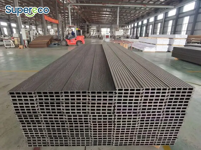 Stacked dark gray WPC decking boards with Square hole profiles